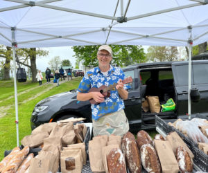 Derek DeGeer, of Hootenanny Breads, serenades shoppers at the Damariscotta Farmers' Market. (Courtesy photo)