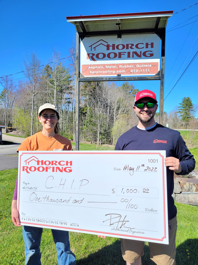 CHIP representative Brittany Gill accepts a $1,000 donation presented on behalf of Horch Roofing's Responsible Giving Committee by company supervisor Bret Butterfield. (Photo courtesy CHIP)