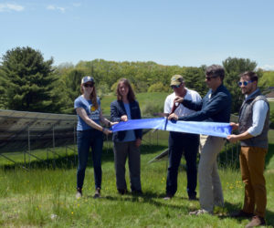 Coastal Rivers Conservation Trust Executive Director Steven Hufnagel cuts a ribbon on the land trust's solar array, located behind its headquarters at Round Top Farm in Damariscotta, on Wednesday, May 25. From left: Allison Barbour, of ReVision Energy; Rep. Lydia Crafts, D-Newcastle; Henry Kennedy, executive director emeritus for Kieve Wavus Education; Hufnagel; and Ethan Tremblay, of the Governor's Energy Office. (Evan Houk photo)