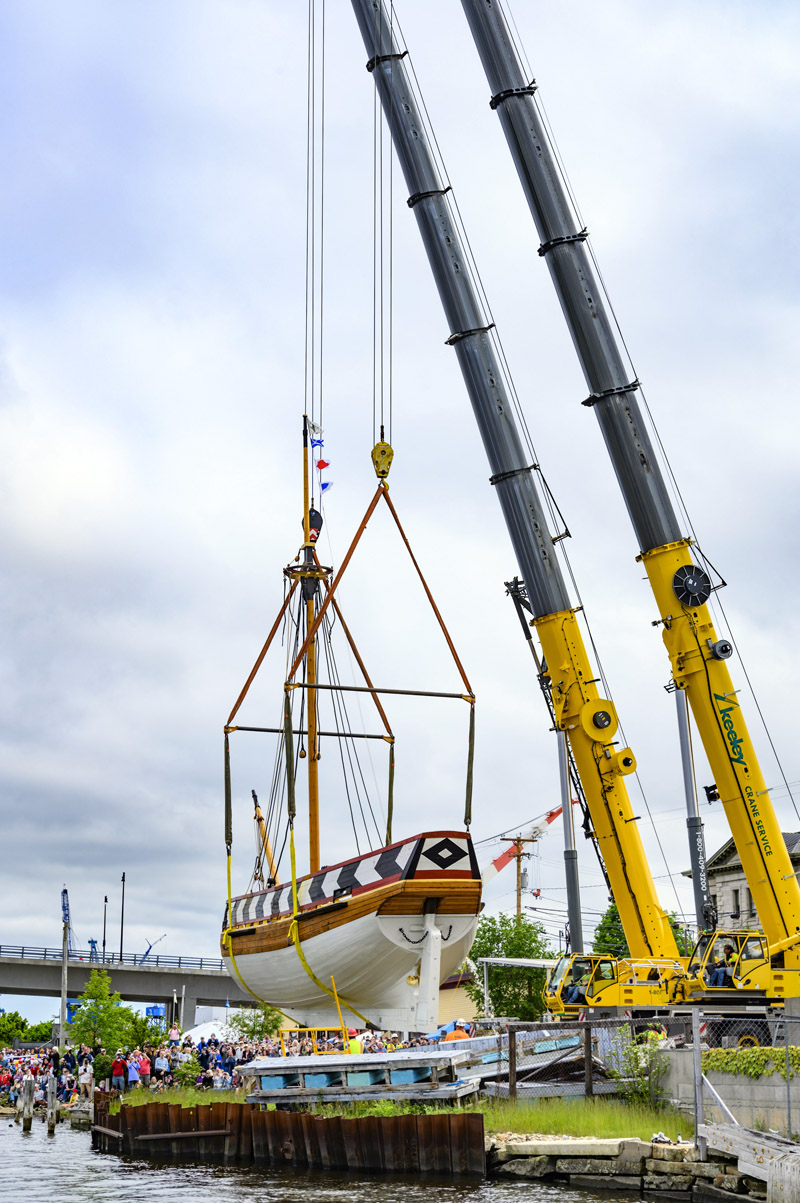 The Virginia hovers over the water as she is lifted from her resting place on the banks of the Kennebec River by two giant cranes in Bath on Saturday, June 4. She was set down in the river so gently that there was barely a splash when she touched the water. (Bisi Cameron Yee photo)