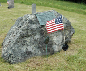 This boulder marks the burial of Rev. Samuel Allen Flagg, a Massachusetts native who settled in Nobleboro on land given him in payment for his service during the Revolutionary War. The boulder originally sat next to the nearby stream and was a favorite seat for Samuel when he was fishing. (Laurie McBurnie photo)