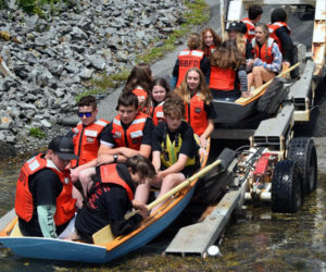 South Bristol School's eighth graders continue the towns maritime tradition as Bittersweet Landing Boatyard owner Mike Nyboe assists with the schools annual boat launch at the towns public landing, Thursday, June 16. The eighth grade class built two traditional style skiffs by hand, working with volunteers at the Maine Maritime Museum in Bath during the school year. (Alec Welsh photo)