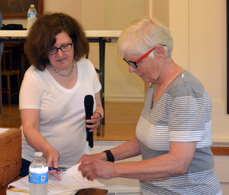 Westport Island Town Clerk Julie Casson (left) swears in newly elected First Selectmen Donna Curry at the annual town meeting on Saturday, June 25. (Charlotte Boynton photo)