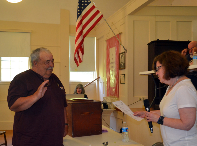Reelected Road Commissioner Garry Cromwell is sworn in by Town Clerk Julie Casson at Westport Islands annual town meeting on Saturday, June 25. (Charlotte Boynton photo)