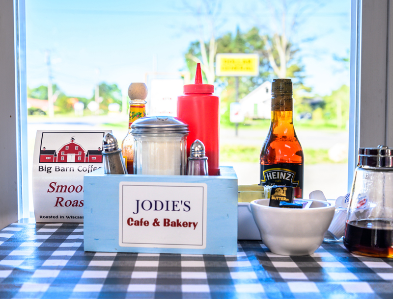 Condiments and menu cards await diners at Jodie's Cafe and Bakery in Wiscasset on Tuesday, June 14.  The restaurant owners have come to the area from Georgia and bring Southern flavors to New England meals.  (Photo by Bisi Cameron Yee)