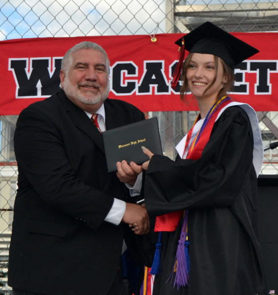 Wiscasset Middle High School Principal Charles Lamonte congratulates graduate Ruby Cassaboon during commencement exercises at the Wiscasset Speedway on Friday, June 10. (Sherwood Olin photo)