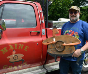 Maine Gravy owner and "saucemaster" Dick Chase holds Dave, the inspiration behind his hot sauce company's logo, in front of The Heatmobile. Chase, of Damariscotta, received permission from William "Bill" Skrips, the artist who created the piece, to modify Dave for the Maine Gravy bottles on Chase's line of hot sauces. (Maia Zewert photo)