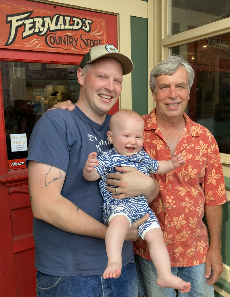 Three generations of the Richards family stand in the doorway of S. Fernald's Country Store in Damariscotta. Sumner Fernald Richards III (right) started the store in 1990. His son Sumner Fernald Ricky Richards IV (left) took over the business in 2016 and now has a son of his own, Sumner Fernald "Sunny" Richards V. (Maia Zewert photo)