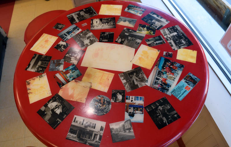 A table with old photos sits at the Waltz Soda Fountain in downtown Damariscotta on Monday, July 11.  Many of the tables and chairs on the counter are original since the soda fountain and pharmacy opened in 1948. (Evan Houk photo)