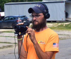 Brandon Simmons films an interview of a driver at the Wiscasset Speedway on Saturday, July 9. Simmons started filming races at the speedway in 2012 with just a cell phone before becoming a speedway employee in 2014. (Alec Welsh photo)