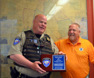 Sheriff Todd Brackett (right) presents Lt. Brenden Kane, of the Lincoln County Sheriff's Office, with the 2021 Deputy of the Year award during a brief ceremony at the Lincoln County Board of Commissioners meeting on Tuesday, July 5. (Charlotte Boynton photo)