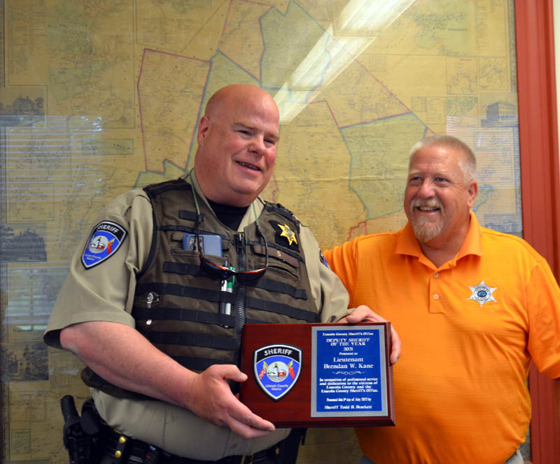 Sheriff Todd Brackett (right) presents Lt. Brenden Kane, of the Lincoln County Sheriff's Office, with the 2021 Deputy of the Year award during a brief ceremony at the Lincoln County Board of Commissioners meeting on Tuesday, July 5. (Charlotte Boynton photo)