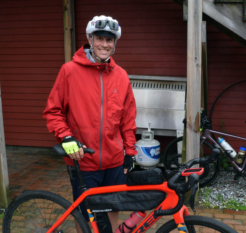 Jeremy Chapman, of Hebron, poses with his bicycle outside the Newcastle Publick House on Monday, June 27. Chapman met up with ultra runner Shan Riggs for a leg of Riggs' journey to become the first person to run the entire 2,960-mile East Coast Greenway. (Evan Houk photo)