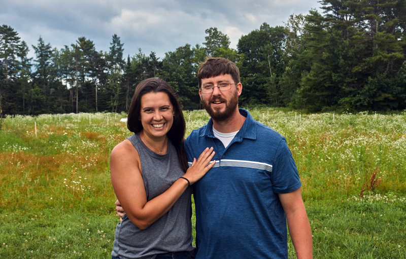 Kailey Smith and Sterling Doiron stand in front of Uprooted Farm in Waldoboro. The couple began the farm in Farmington before relocating it to Waldoboro in December 2021. (Aiden Jacobs photo)