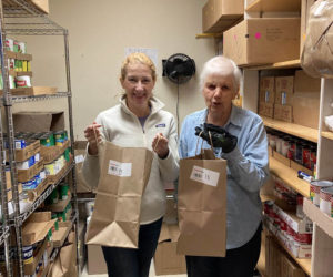 Ecumenical Food Pantry volunteers show off their favorite bags. (Photo courtesy Ellen Dickens)