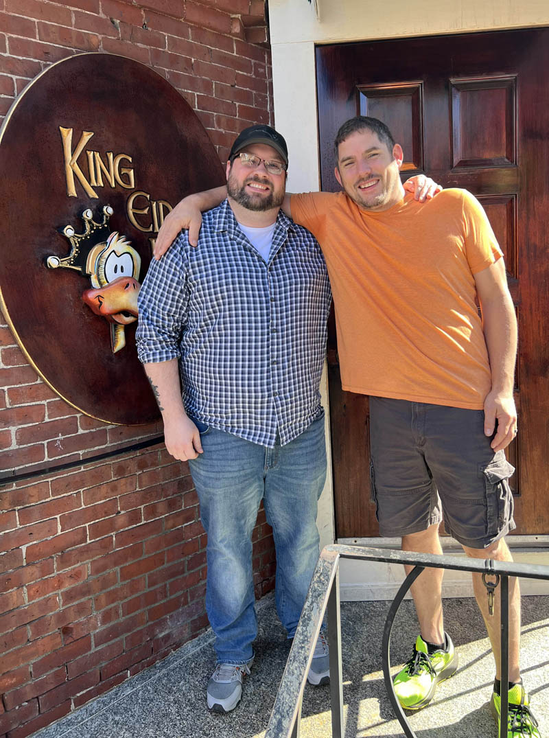 New King Eiders Pub owners Damon Waltz (left) and Scott McArdle pose of the steps of the Damariscotta business. (Photo courtesy King Eider's Pub)