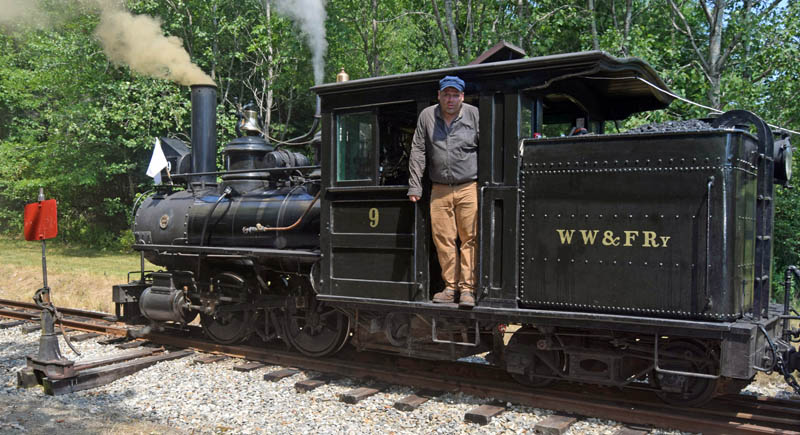 Bryce Weeks stands in the doorway of Locomotive 9 at the Alna station on Saturday, Aug. 6. Weeks served as the locomotive's fireman, a responsibility that requires shoveling coal into the boilers firebox. Weeks was part of the grand opening for the Wiscasset, Waterville & Farmington Railway's Mountain Extension. (Alec Welsh photo)