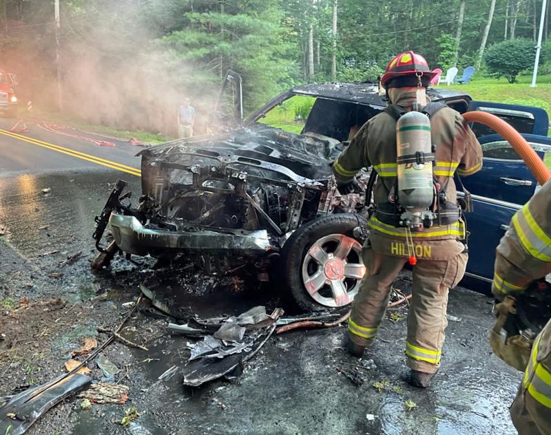 A firefighter extinguishes a blaze in a blue Chevrolet Silverado that crashed on Biscay Road in Bremen on the evening of Tuesday, Aug. 2. The driver, Roy Benner, of Damariscotta, was LifeFlighted to Maine Medical Center in Portland. (Photo courtesy James Genthner)