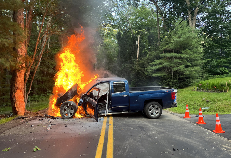 A blue Chevrolet Silverado is engulfed in flames after leaving Biscay Road and striking a tree in Bremen on the evening of Tuesday, Aug. 2. Bystanders and members of the Bremen Fire Department were able to extract the driver, Roy Benner, of Damariscotta, and he was LifeFlighted to Maine Medical Center in Portland. (Photo courtesy Lincoln County Sheriff's Office)