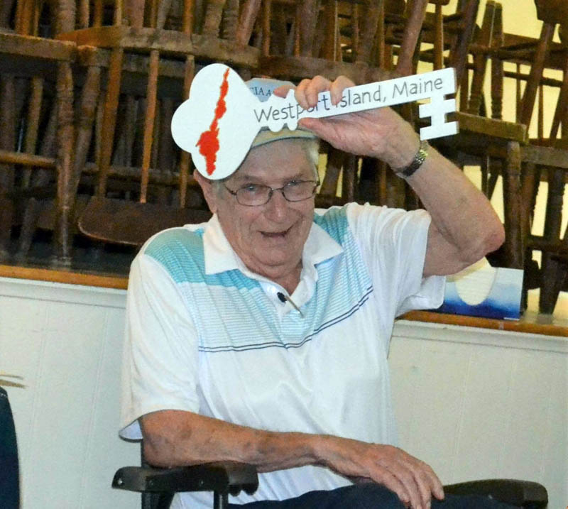 Former Westport Island First Selectman George Richardson Jr. displays a wooden key to the town presented to him by Town Clerk Julie Casson during the celebration of his service on Sunday, July 31. (Charlotte Boynton photo)