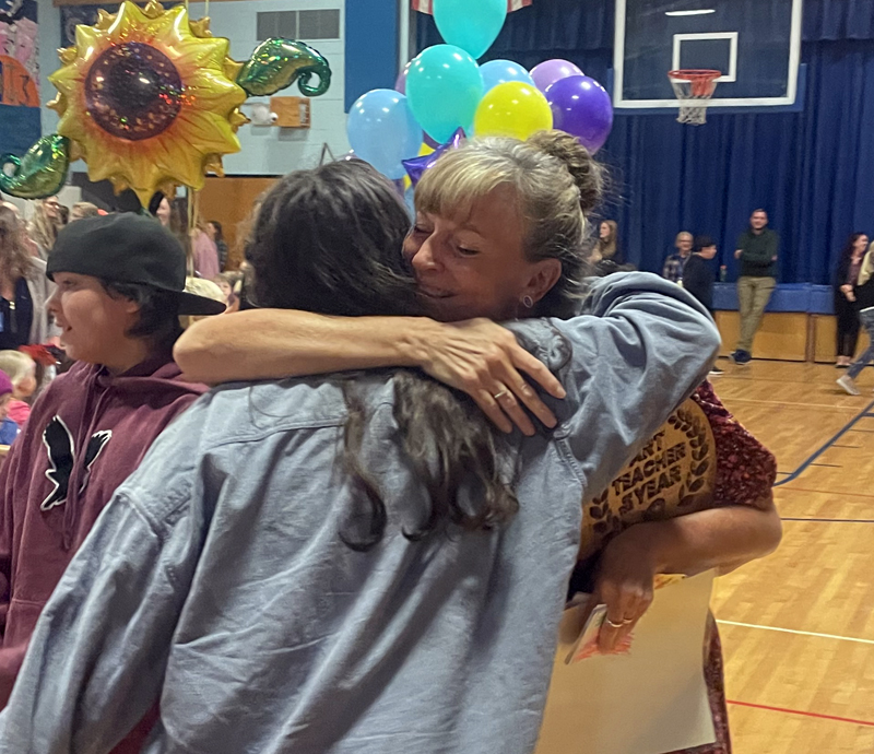 Karen Hight gives a hug while thanking a line of well-wishers filing out of the Great Salt Bay Community School gymnasium on Friday, Sept. 23. A school assembly recognized Hights receiving one of the 10 inaugural Prang Art Teacher of the Year awards. (Sherwood Olin photo)