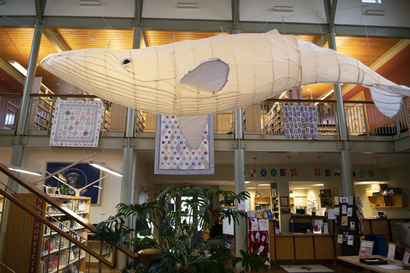 A 20-foot white whale floats above the first floor of the Skidompha Library in Damariscotta on Sunday, Sept. 11. The sculpture is crafted from wood, PVC pipe, and nonwoven cloth, and lit from within by strips of miniature LED lights. (Bisi Cameron Yee photo)
