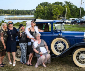 From left: Kim Traina, Suzanne Strachan, Paula Gove, Stephanie Danahy, and Lorrie Winslow pose with a Model A Ford during the Lincoln Home's 95th birthday celebration in Newcastle Saturday, Aug. 20. Classic cars and a box of costume elements including feather boas, fans, and pearls gave guests an opportunity to relive the Roaring Twenties. (Bisi Cameron Yee photo)