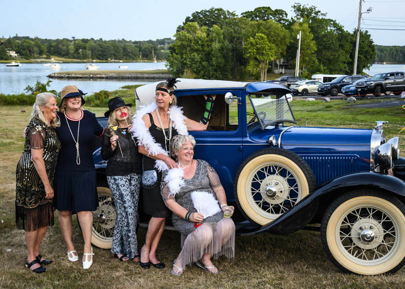 From left: Kim Traina, Suzanne Strachan, Paula Gove, Stephanie Danahy, and Lorrie Winslow pose with a Model A Ford during the Lincoln Home's 95th birthday celebration in Newcastle Saturday, Aug. 20. Classic cars and a box of costume elements including feather boas, fans, and pearls gave guests an opportunity to relive the Roaring Twenties. (Bisi Cameron Yee photo)