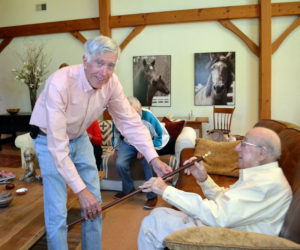 Westport Island Select Board member Jeff Tarbox presents the Boston Post Cane to Mort Mendes, in recogniton of Mendes's status as the oldest citizen on the island. (Charlotte Boynton photo)