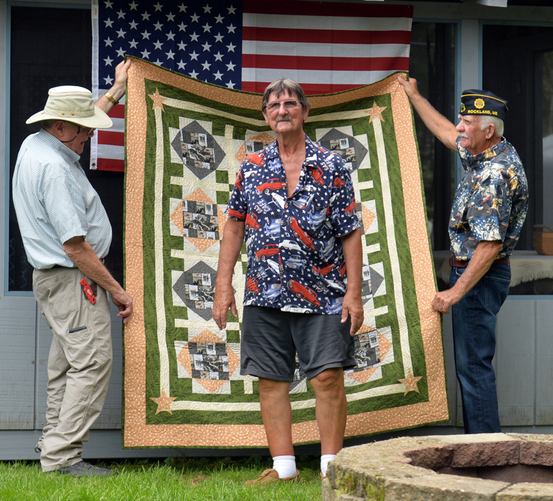 Vietnam veteran Stanley Winchenbach, of Waldoboro, stands in front of quilt presented to him in a Quilts of Appreciation ceremony in Nobleboro. (Paula Roberts photo)
