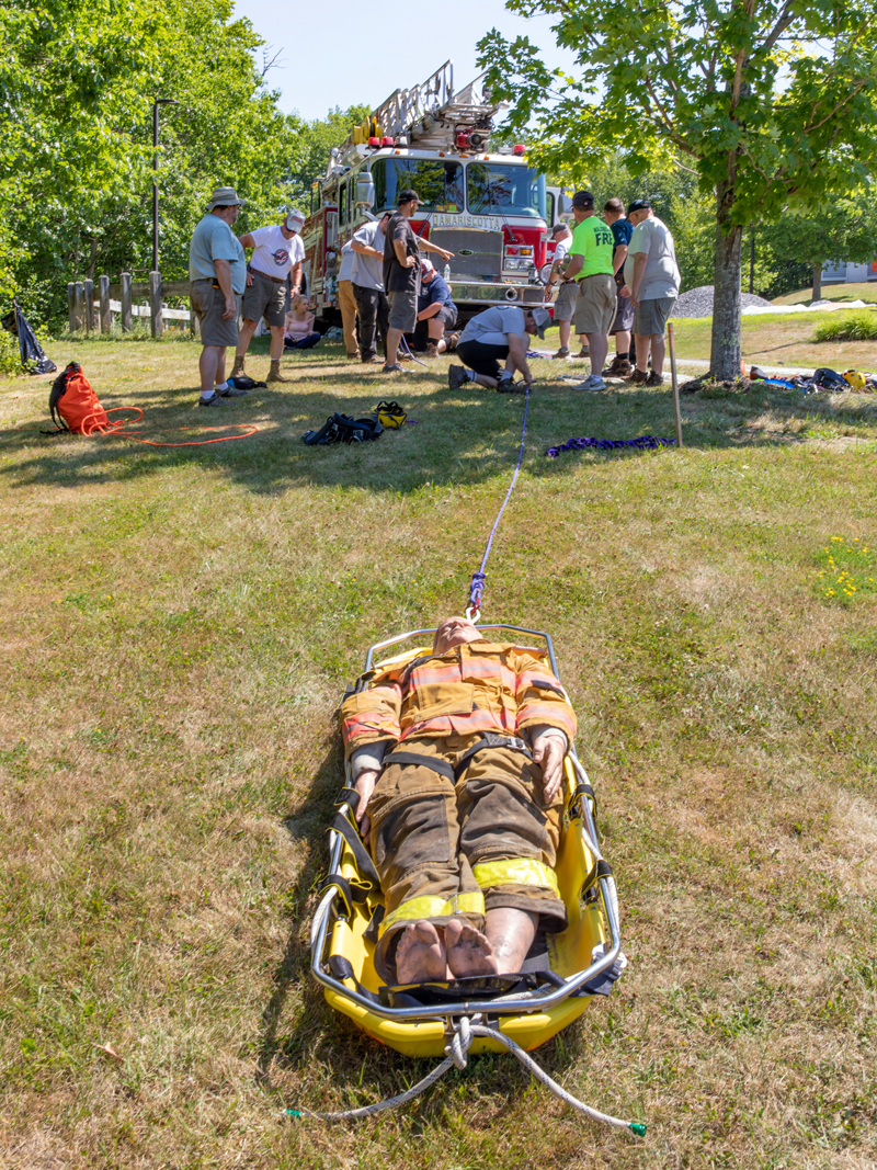 A 200-lbs. rescue dummy makes the ascent up the hill during a technical rescue class. Firefighters rigged a system of ropes, pulleys and appliances to Damariscotta Ladder 4 in order to hoist the basket up the hill to safety. (Photo courtesy Kyle Santheson)