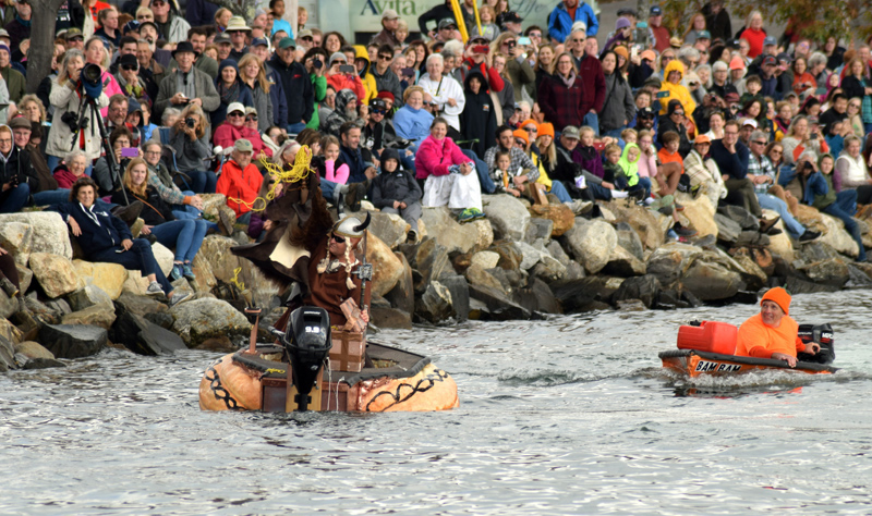Russell Orms, of Austin, Texas, holds up the "gnome gold" he retrieved from a floating treasure chest as Buzz Pinkham looks on during the 13th annual Damariscotta Pumpkinfest Regatta on Oct. 14, 2019. The Twin Villages is holding the first parade and regatta since 2019 and traffic patterns will be altered in town. (Evan Houk photo, LCN flie)