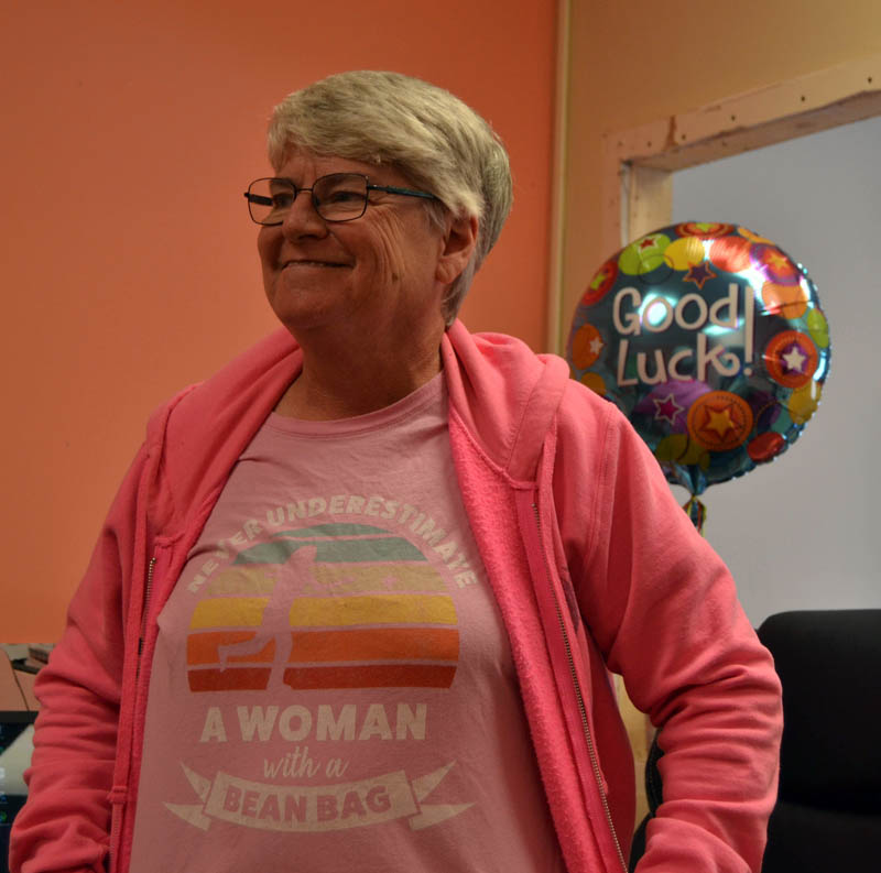 Penny Dostie displays a cornhole-themed T-shirt in her Waldoboro office at The Cornhole Connection. Dostie celebrated the grand opening of the business at its new Waldoboro location on Saturday, Oct. 1. (Elizabeth Walztoni photo)