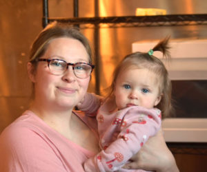 Katie's Kakes owner Katie Genthner holds her daughter Winsley at the business's location on Friendship Street in Waldoboro. (Elizabeth Walztoni photo)