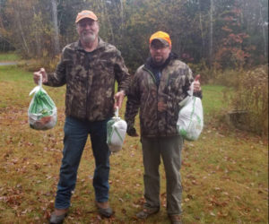Previous competition winners Tom Johnson and Mike Cushing with their turkey prizes. (Photo courtesy Samoset Fish and Game Club)