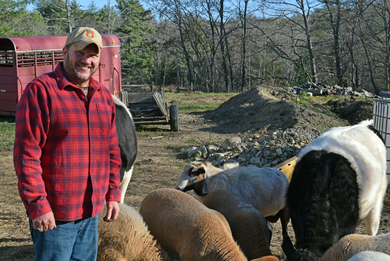 Walter Greene-Morse stands with his livestock at his Jefferson homestead, Patriot Ridge Farm, on Tuesday, Nov. 8. Greene-Morse and his wife grow food for themselves and friends and family on the farm and he hosts fly-fishing trips for veterans. (Evan Houk photo)
