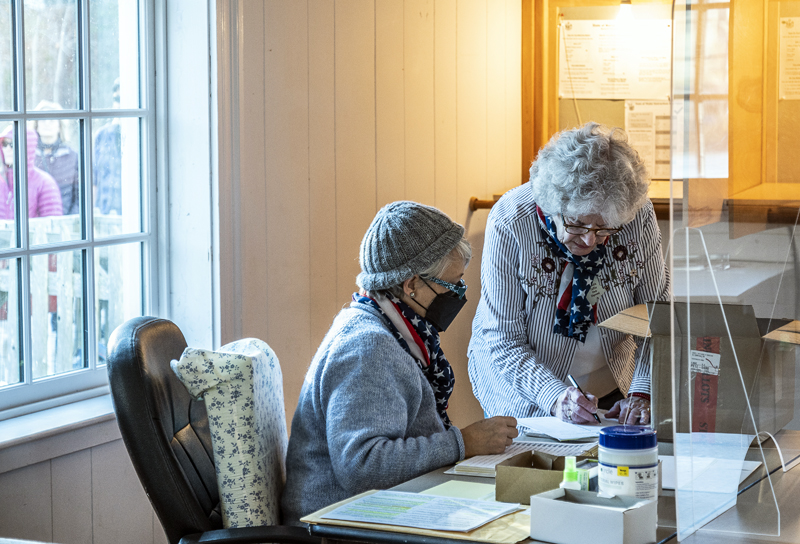 Poll worker Martha Speed (left) and Edgecomb Town Clerk Claudia Coffin prepare for the arrival of voters on Tuesday, Nov. 8. (Bisi Cameron Yee photo)