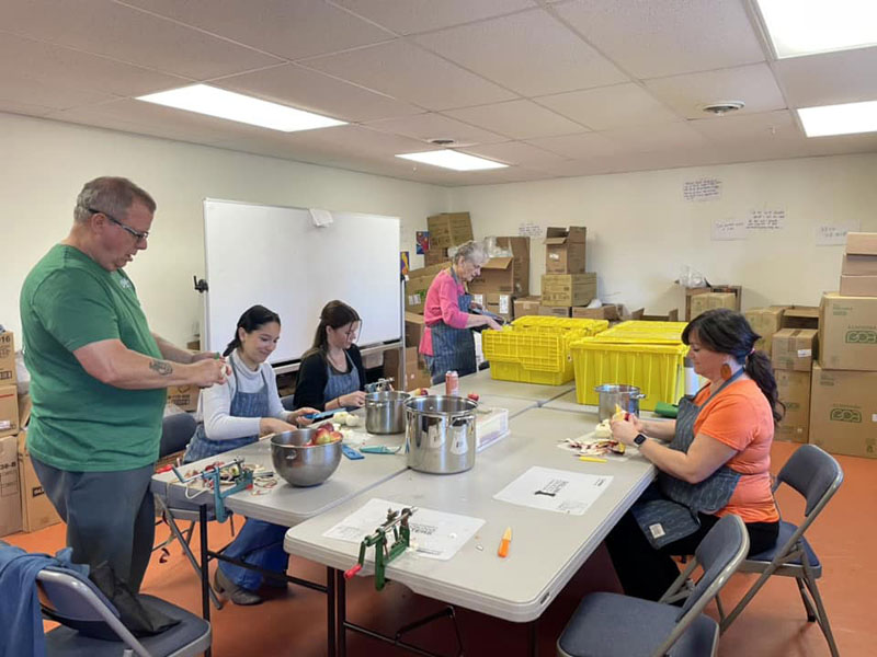 Lincoln County Gleaner volunteers peel and core apples for applesauce. (Photo courtesy Healthy Lincoln County)