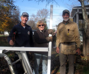 CHIP volunteers Breck, Sandy, and Phillip take advantage an unseasonably warm, late fall day to hang gutters for a neighbor as part of a CHIP repair project. (Photo courtesy Community Housing Improvement Project)