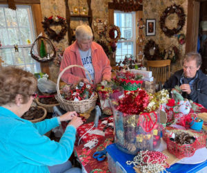 Led by Betty Lou Townsend, center, Beacon Chapter #202 Craft Club members, Nylene Page (left) and Joan Hodgdon, make Christmas decorations to be sold at the chapters Annual Christmas Bazaar. (Photo courtesy Fran Hewins)