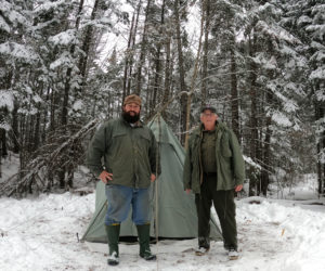 Jefferson men Joe Holland (left) and Donnie Johnston stand in front of Johnston's old time camping equipment on a winter camping trip last winter. (Photo courtesy Joe Holland)