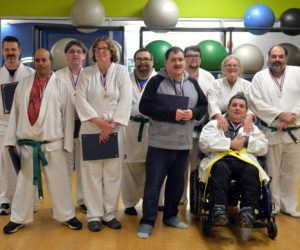 Mobius' karate class stands for a photo after a belt test and promotion ceremony on Wednesday, Nov. 16 at the CLC YMCA in Damariscotta. From left: Joshua Strong, Will Gross, Matthew Brough, Laurie Curtis, Matt Harvey, Michael Turner, Ben Olmstead, sensei Linda Porter, Ricky Cook, and Jay Tattan. (Paula Roberts photo)