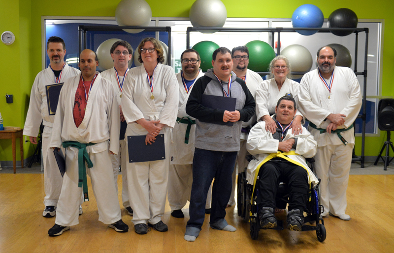 Mobius' karate class stands for a photo after a belt test and promotion ceremony on Wednesday, Nov. 16 at the CLC YMCA in Damariscotta. From left: Joshua Strong, Will Gross, Matthew Brough, Laurie Curtis, Matt Harvey, Michael Turner, Ben Olmstead, sensei Linda Porter,  Ricky Cook, and Jay Tattan. (Paula Roberts photo)