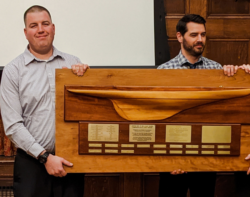 Hannaford Damariscotta store manager Ben Convery accepts the United Way of Mid Coast Maine 2022 Campaign Excellence Award on behalf of Hannaford District 3 from 2021 award winner, Bath Savings representative Dan Wilson. (Photo courtesy United Way of Mid Coast Maine)