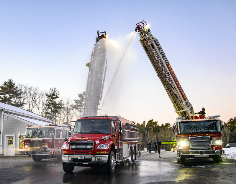 Damariscotta and Waldoboro ladder trucks perform a wetdown ceremony to welcome Bremen's new fire truck into service in Damariscotta on Tuesday, Dec. 20. The tradition dates back to the late 1800s when firefighters washed the horses and firefighting apparatus after a fire. (Bisi Cameron Yee photo)