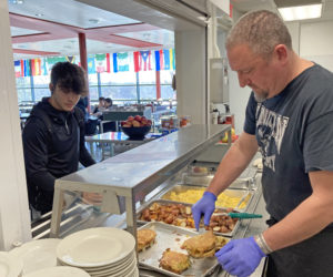 Chef Chad McKernan (right) serves stuffed French toast to a residential Lincoln Academy student during brunch on Sunday, Dec. 4. (Maia Zewert photo)