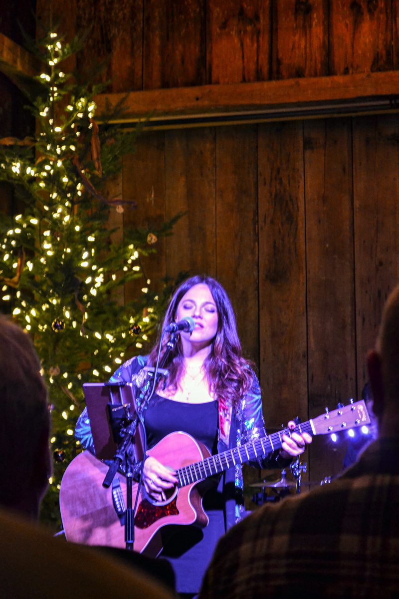 Cara Brindisi performs an original song while playing acoustic guitar. (Lydia Simmons photo)