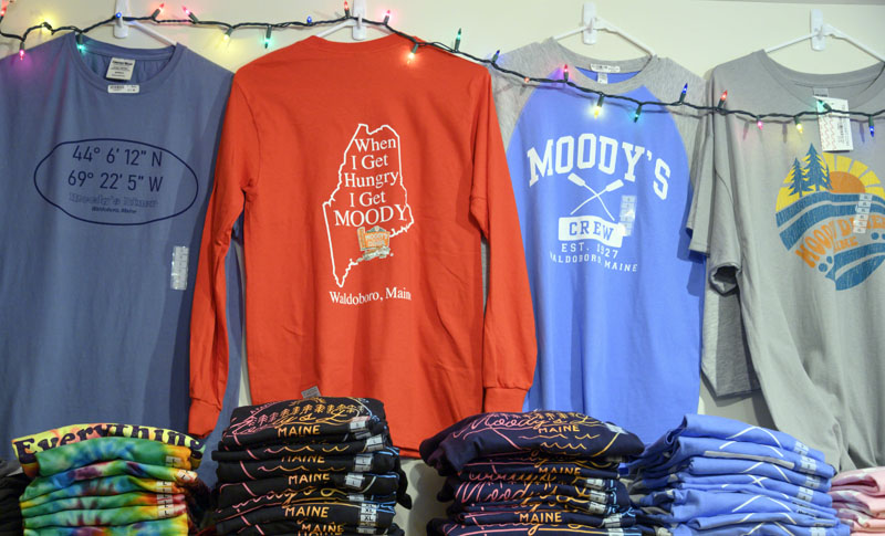T-shirts fill a display at Moody's Gifts in Waldoboro on Monday, Dec. 12. As a co-owner of the iconic Moody's Diner, Nancy Genthner realized the power of the Moody brand and initiated a merchandise collection that started with T-shirts and grew to include a wide variety of items featuring the Moody name and its defining slogans. (Bisi Cameron Yee photo)