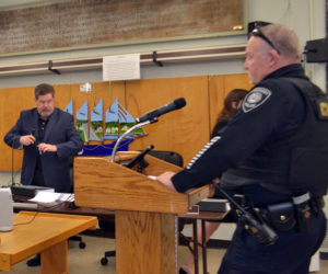 Deputy Director of the State Bureau of Alcoholic Beverages Timothy Poulin (left) listens as Wiscasset Police Chief Larry Hesseltine (right) testifies during a public hearing at the Wiscasset municipal building on Oct. 13. (Charlotte Boynton photo, LCN file)