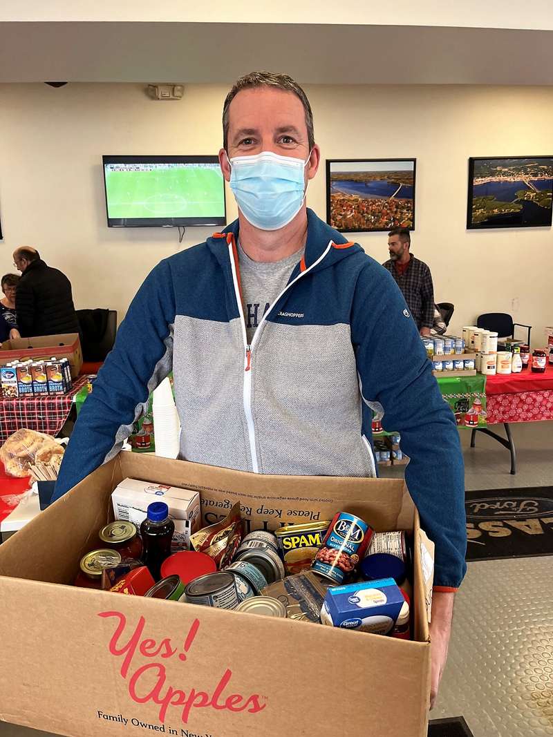 Wiscasset Ford General Sales Manager Andrew Whittaker packs boxes for patrons in the dealer's first food pantry.  (Photo Credit: Healthy Lincoln County)